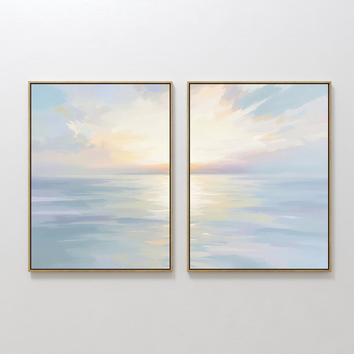 The Ethereal Waters - Set of 2 features framed abstract paintings of tranquil seascapes in soft pastel blues, pinks, and yellows with sunrise or sunset reflections, displayed side by side for serene wall decor.