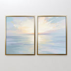 The "Ethereal Waters - Set of 2" features framed paintings of a serene seascape with calm water and a pastel sky in soft blue, yellow, and pink tones—ideal coastal artwork for creating tranquil spaces.