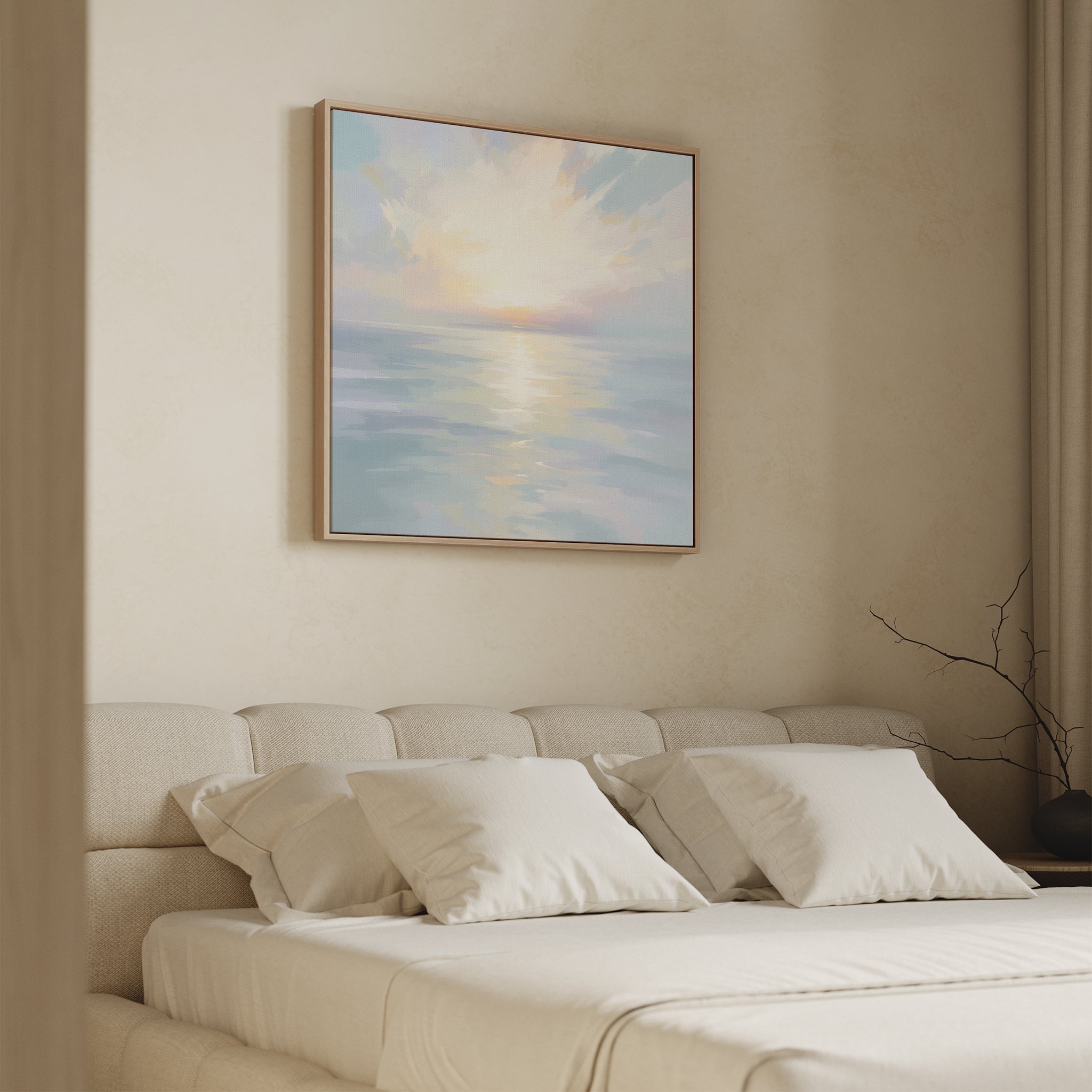 A serene bedroom features a beige bed, white pillows, and the Ethereal Waters Canvas Art - Square—a large pastel seascape—above the headboard. Natural light and minimal decor enhance the calm, peaceful atmosphere.