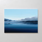 The Fjord Mist Canvas Art - Horizontal features a serene landscape of a calm lake, blue skies, misty mountains, and low clouds—creating a tranquil home decor accent for any space.