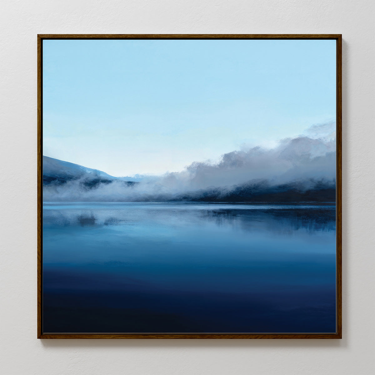 The Fjord Mist Canvas Art - Square features a framed serene landscape of a calm lake and misty mountains under a pale blue sky, with cool-toned colors perfect for Nordic wall art or creating tranquil bedroom decor.