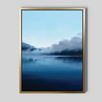 The Fjord Mist Canvas Art - Vertical features a serene lake with calm blue water, distant mountains, and drifting mist—ideal Nordic decor to complement any light gray wall.