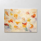 The Floating Petals Canvas Art - Horizontal features orange, yellow, and green abstract petals drifting on a soft pastel background, adding organic elegance and movement when displayed on a plain white wall.