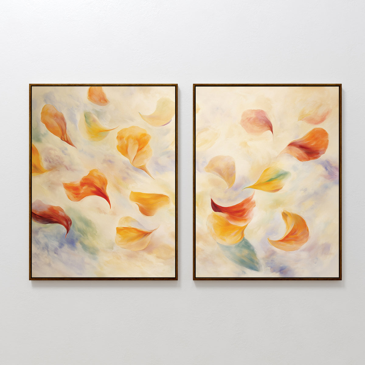 The Floating Petals - Set of 2 features framed abstract canvas prints with soft, swirling shapes in warm orange, yellow, and red tones, accented by green and blue on a creamy background—evoking the look of floating petals.