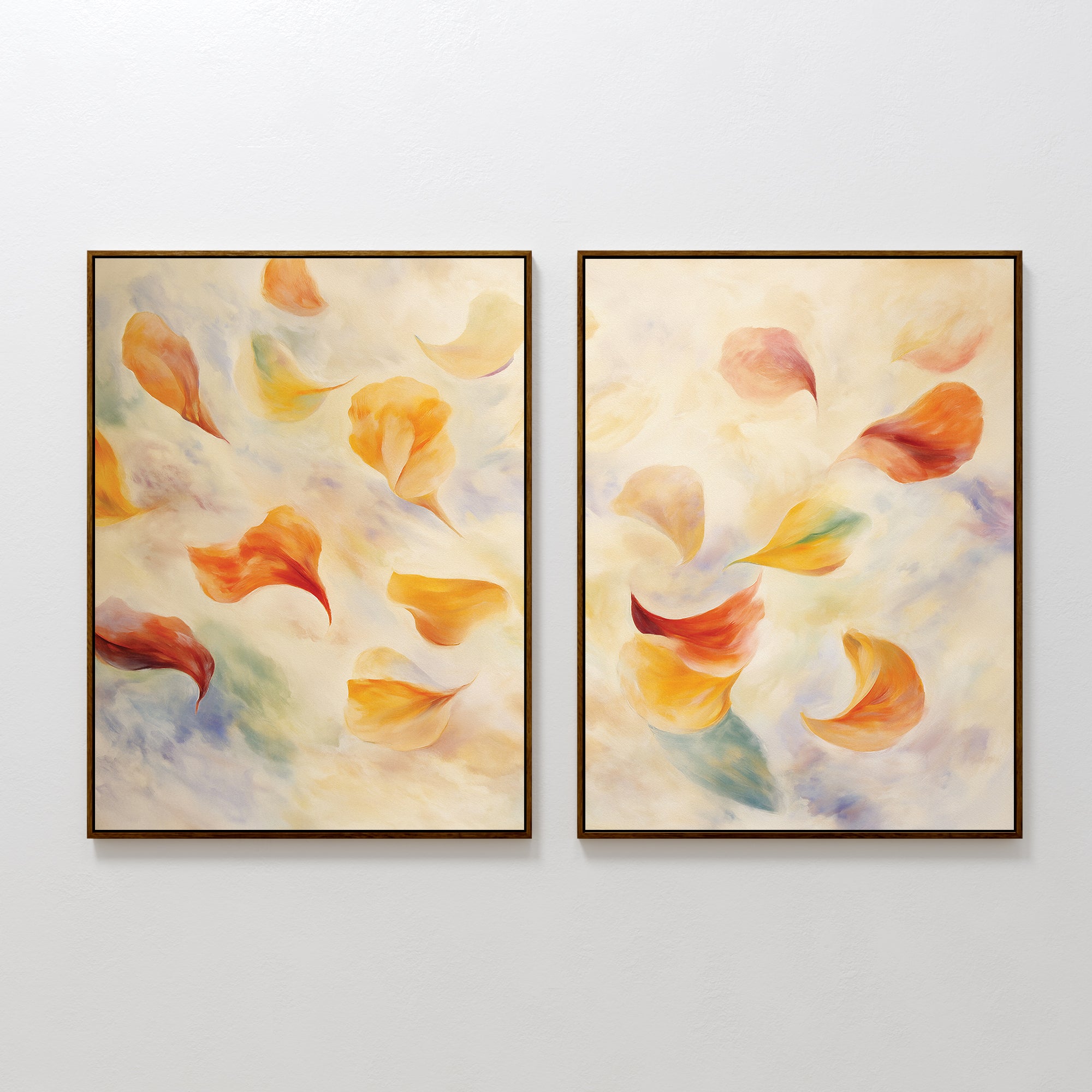 The Floating Petals - Set of 2 features framed abstract canvas prints with soft, swirling shapes in warm orange, yellow, and red tones, accented by green and blue on a creamy background—evoking the look of floating petals.