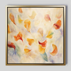 The Floating Petals Canvas Art - Square displays swirling abstract petals in orange, yellow, and red on a soft blue and cream background. Encased in a simple metallic gold frame, it brings organic elegance to any space.