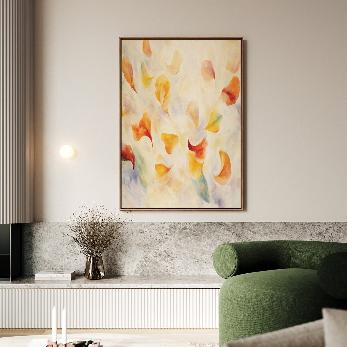 A modern living room with a green curved sofa, the "Floating Petals Canvas Art - Vertical" featuring soft orange and yellow shapes, a marble ledge with a vase of twigs, and minimalistic decor that exudes organic elegance.