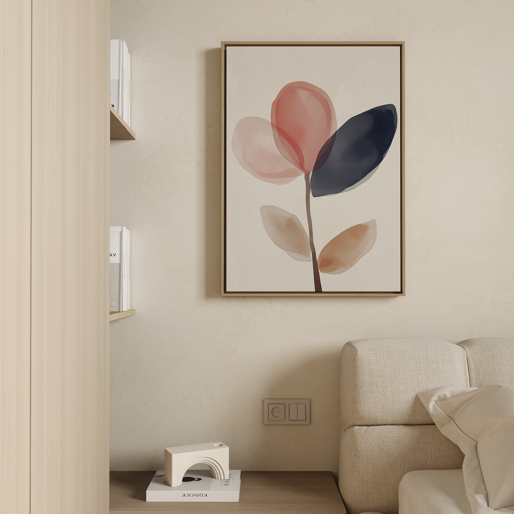 A minimalist living room featuring a beige couch and the Petal Breeze Canvas Art—abstract red, navy, and beige leaves—on the wall, with wooden shelves of books and a small white floor lamp for stylish decor.