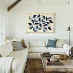 A bright, cozy living room with white shiplap walls, a large white sectional sofa and assorted pillows, a rustic wooden coffee table, and the Flowing Shadows Canvas Art - Horizontal that adds modern style to the space.