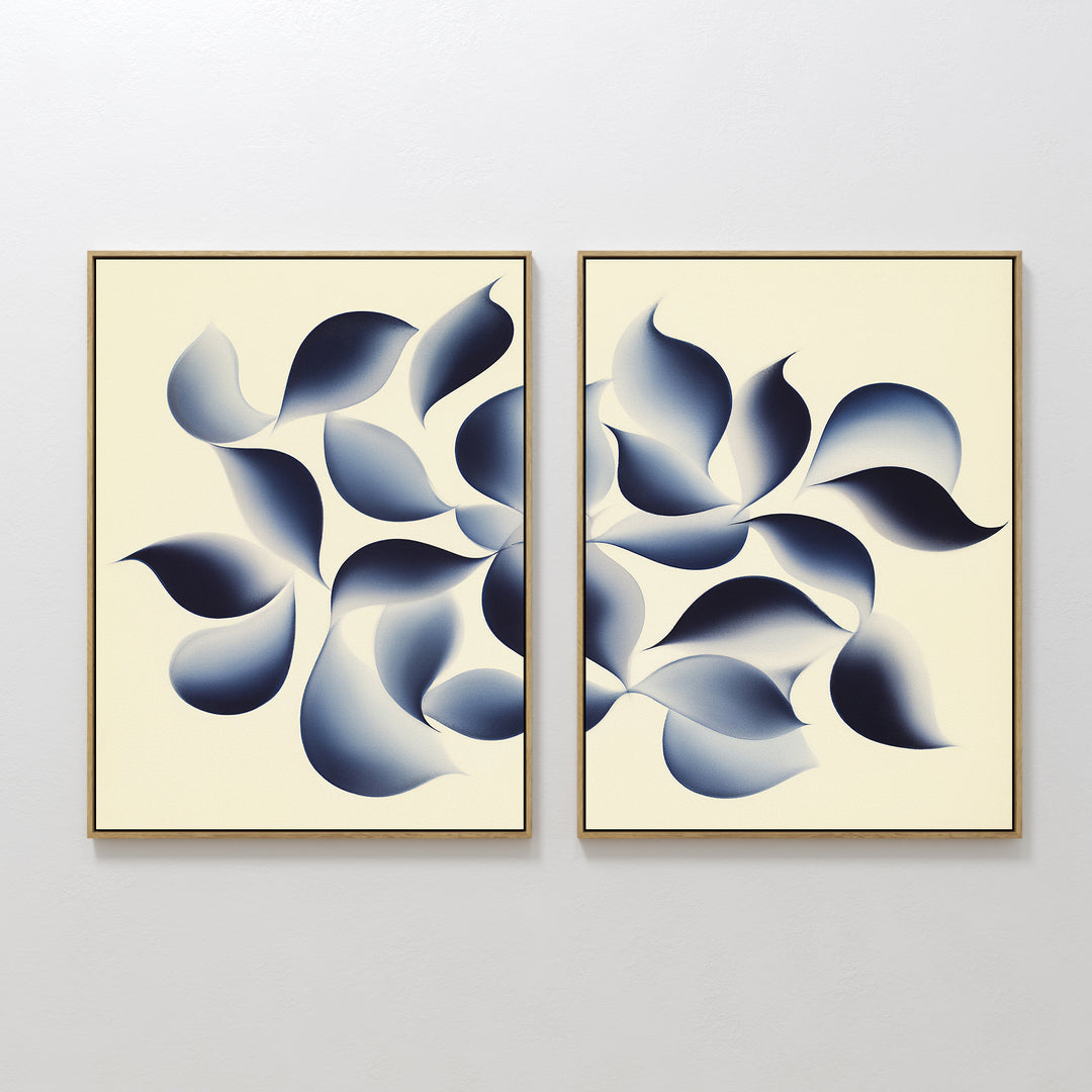 Flowing Shadows - Set of 2 showcases abstract framed canvas prints with leaf-like shapes in deep indigo on a cream background, creating dynamic and modern wall art ideal for contemporary living room decor.