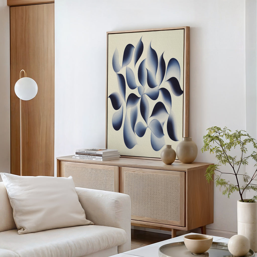 A modern living room with a light wood sideboard, Flowing Shadows Canvas Art - Vertical above, a white sofa with cushions, a round coffee table with decor, a potted plant, and a globe-shaped floor lamp creates serene, stylish decor.