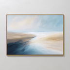 The Fluid Motion Canvas Art - Horizontal features soft blue, beige, and white tones blended in smooth brushstrokes, creating a serene coastal vibe. Perfect for modern living rooms, this abstract print comes framed in a thin gold frame.