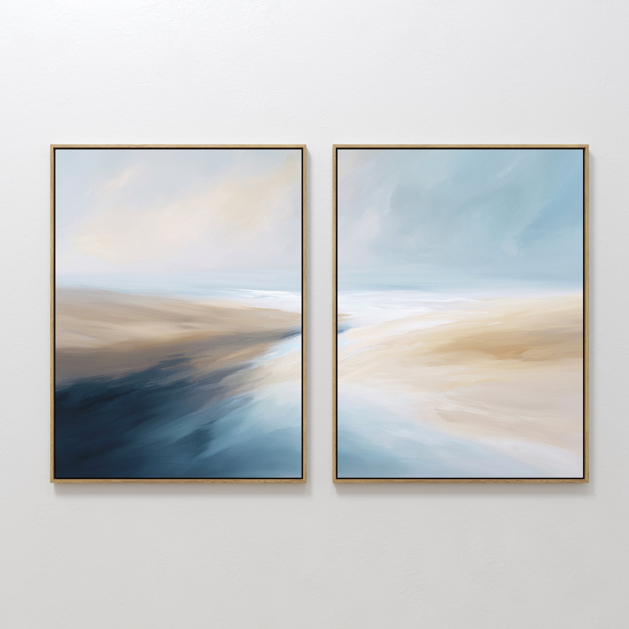 Fluid Motion - Set Of 2 features two abstract prints in gold frames with soft swirls of blue, beige, and white. Ideal as coastal wall art or serene decor for modern living rooms, these pieces add a calming touch with their flowing brushstrokes.
