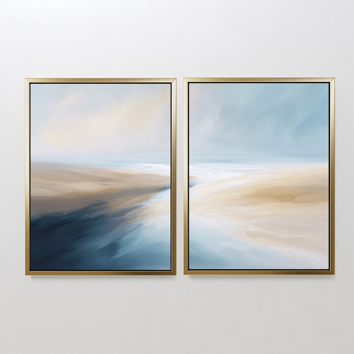 Fluid Motion - Set Of 2 features two abstract prints in gold frames with soft blue, beige, and white blends, ideal as coastal wall art for a modern living room and evoking a serene, flowing landscape.