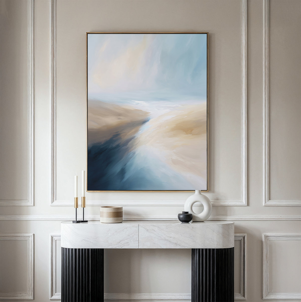 A modern living room features the Fluid Motion Canvas Art - Vertical, with blue, beige, and white tones above a white console table decorated with minimalist accents—ideal for fans of modern living room decor.