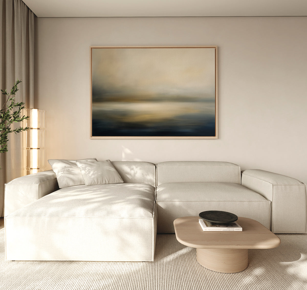 A modern living room with a light beige sectional, a light wood coffee table, decorative black bowl, potted plant, and serene decor highlighted by the Foggy Bay Impressions Canvas Art - Horizontal above the sofa.