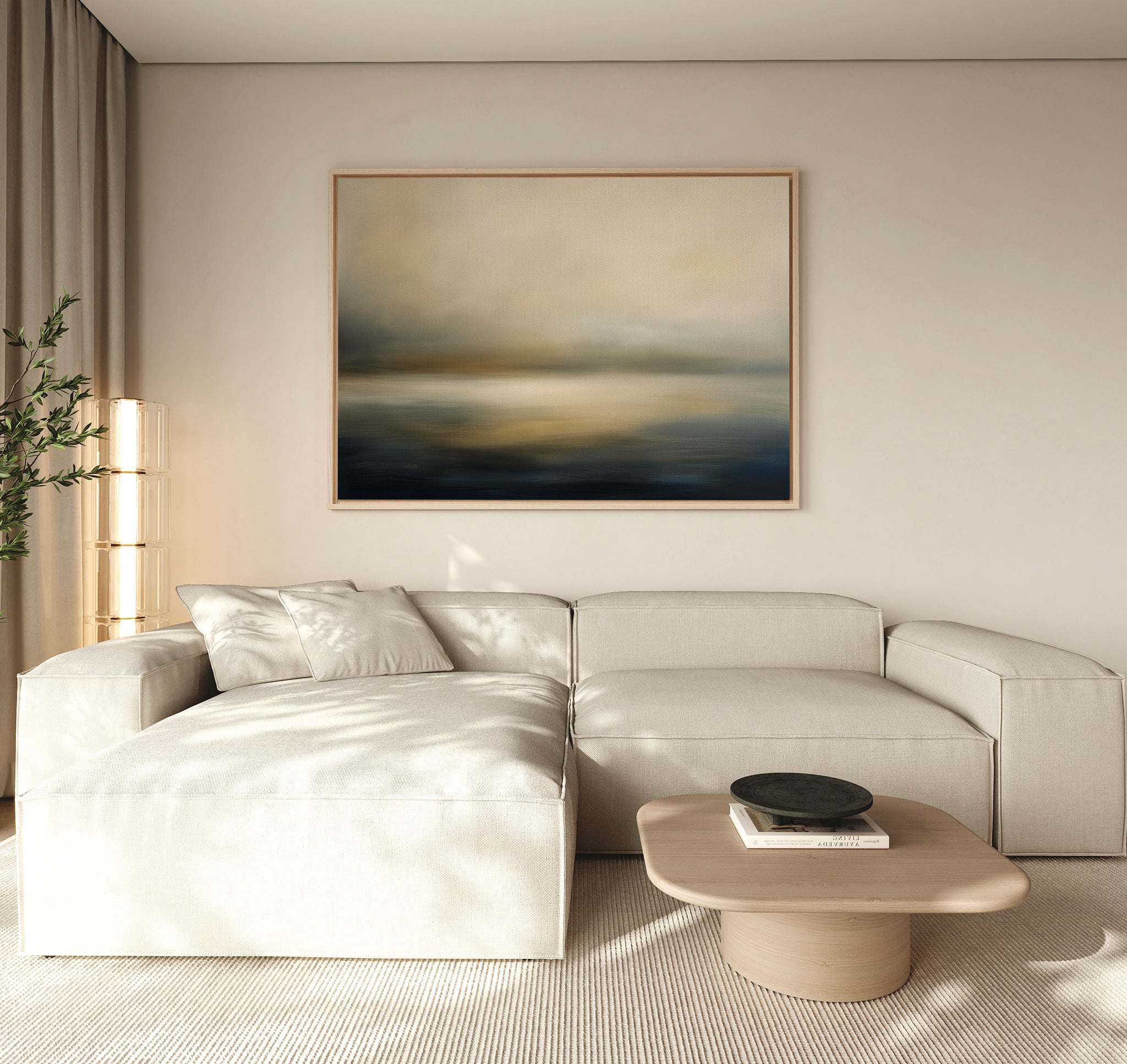 A modern living room with a light beige sectional, a light wood coffee table, decorative black bowl, potted plant, and serene decor highlighted by the Foggy Bay Impressions Canvas Art - Horizontal above the sofa.