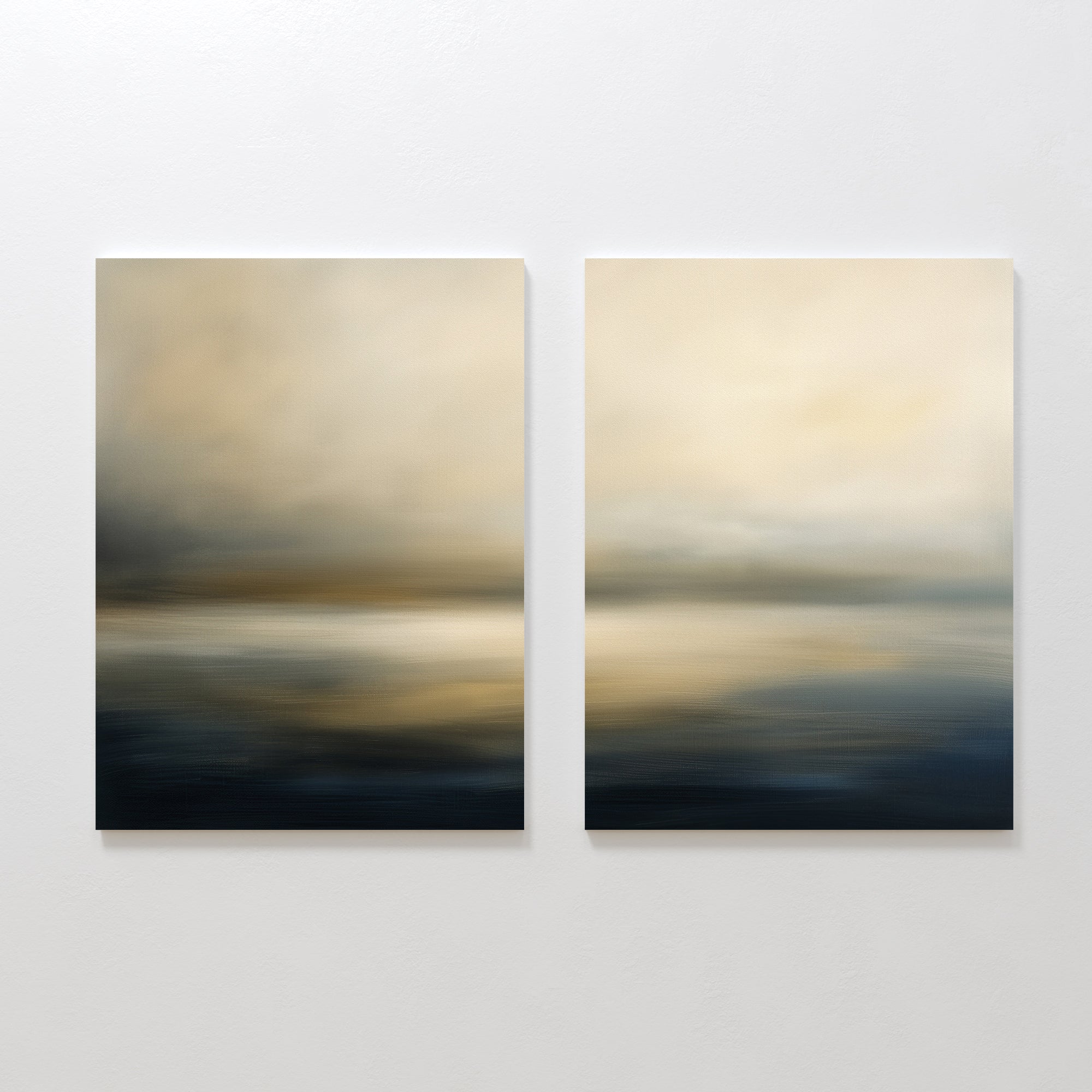 Foggy Bay Impressions - Set Of 2 features square abstract wall art with soft, blurred horizontal bands of beige, gold, and dark blue, creating a calm seascape vibe. These serene pieces are displayed side by side on a white wall.