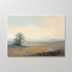 The Foggy Solitude Canvas Art - Horizontal features a soft, muted landscape of a lone tree on a grassy hill under a hazy sky, adding calm and serene beauty—perfect for tranquil bedroom decor.