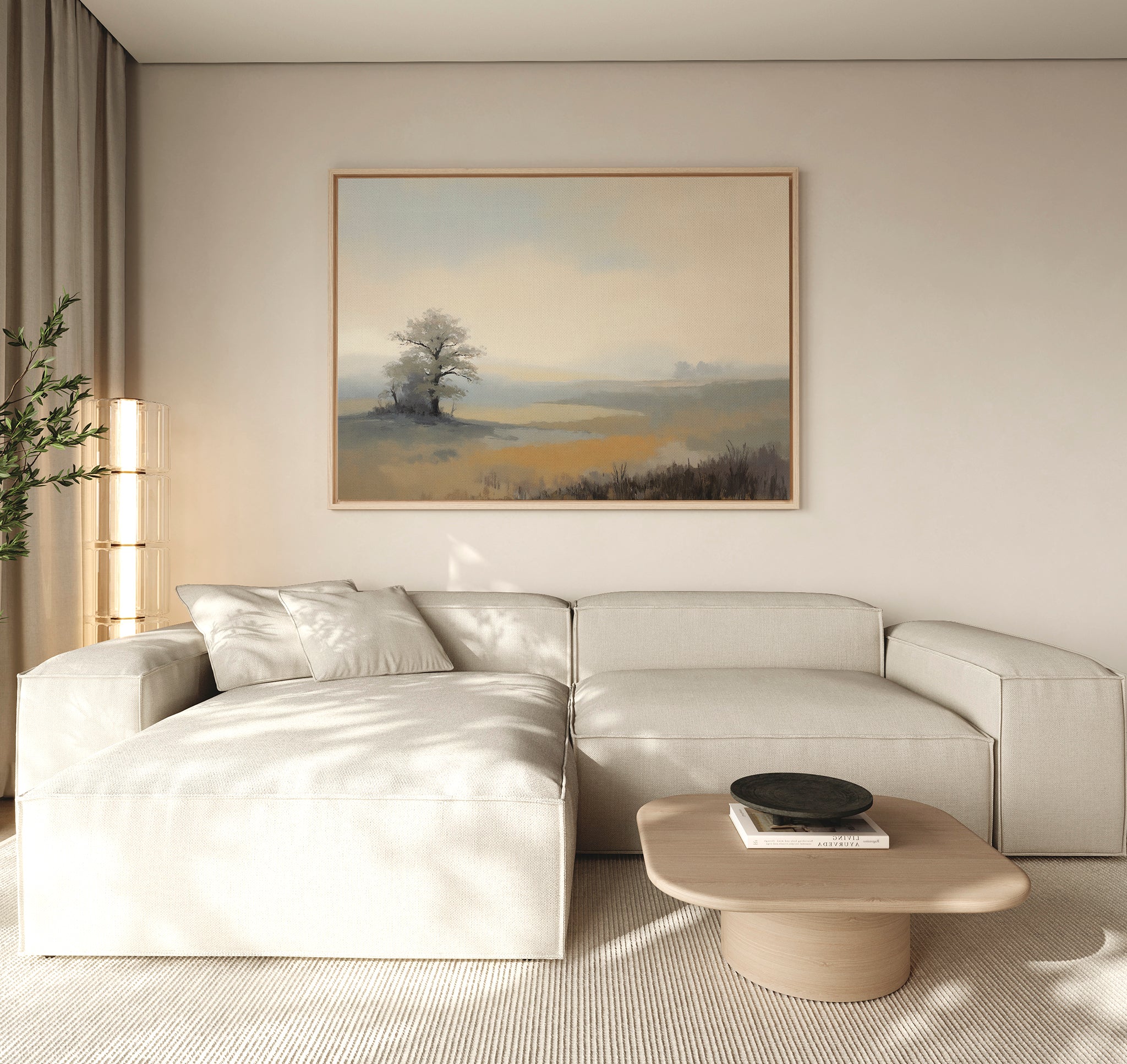 A modern living room features a light beige sectional, wooden coffee table, potted plant, and the Foggy Solitude Canvas Art - Horizontal above. Sunlight filters through sheer curtains, creating a peaceful setting perfect for serene bedroom decor too.