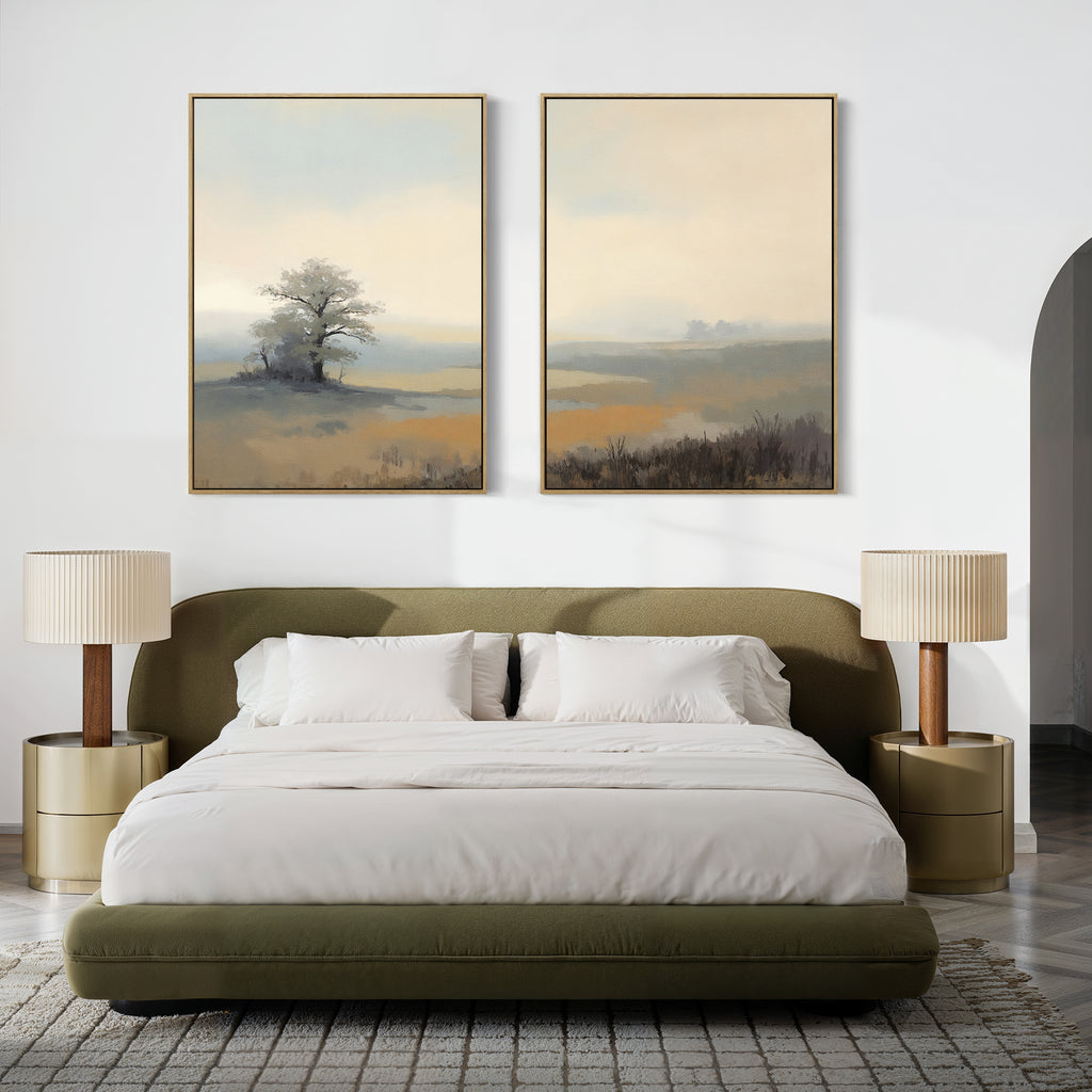 A modern bedroom with an olive green bed, white bedding, round nightstands with beige lamps, and tranquil wall decor—Foggy Solitude - Set of 2, large misty landscape art featuring trees and soft colors above the headboard.
