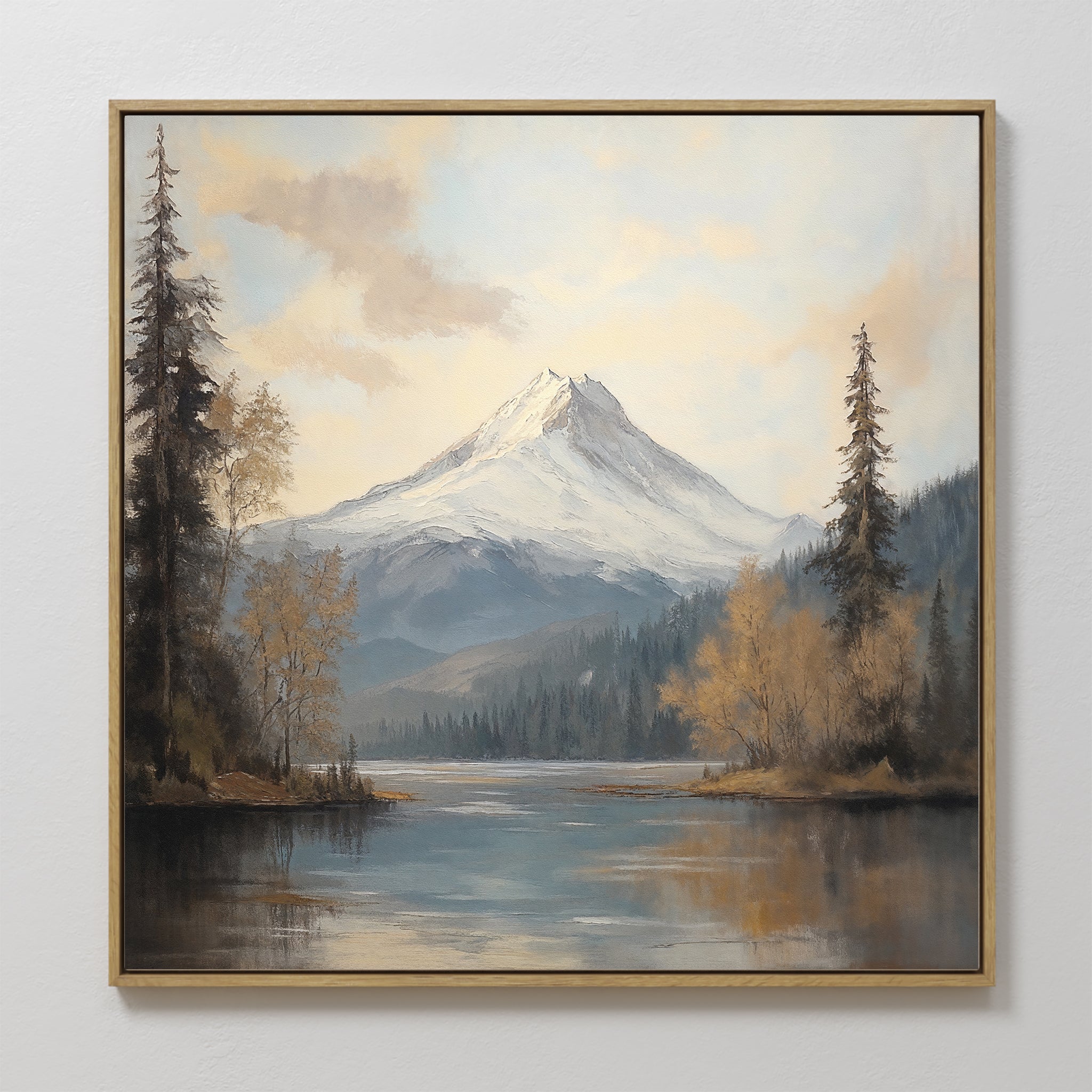 The Frosted Ascent Canvas Art - Square features a snow-capped mountain reflected in serene waters, framed by evergreens and fall colors beneath a partly cloudy sky—an ideal piece of tranquil wall art for any space.