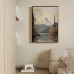 A cozy living room with a beige sofa, a low shelf with books and decor, and tranquil nature vibes—a "Frosted Ascent Canvas Art - Vertical" featuring mountains and a serene lake—hanging above the sofa.