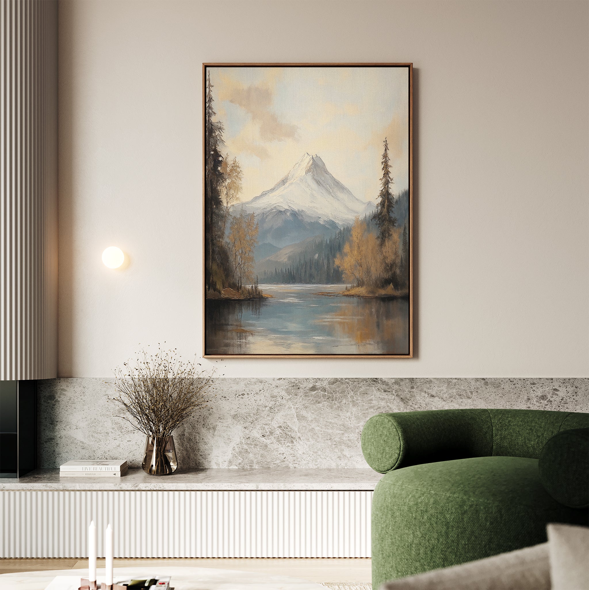 A living room with a green sofa, marble accents, and tranquil decor featuring the Frosted Ascent Canvas Art - Vertical above a shelf with a vase of dried branches.
