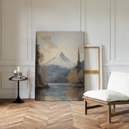 Frosted Ascent Canvas Art - Vertical, featuring a snow-capped mountain by a lake, rests against a white-paneled wall in a bright room with herringbone wood floors, a cushioned chair, candles on a small table, and an empty frame.
