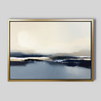 The Frozen Bay Canvas Art - Horizontal features soft blends of blue, beige, white, and black for a serene winter waterscape. In a gold frame, it's perfect for modern living rooms with plain gray walls.