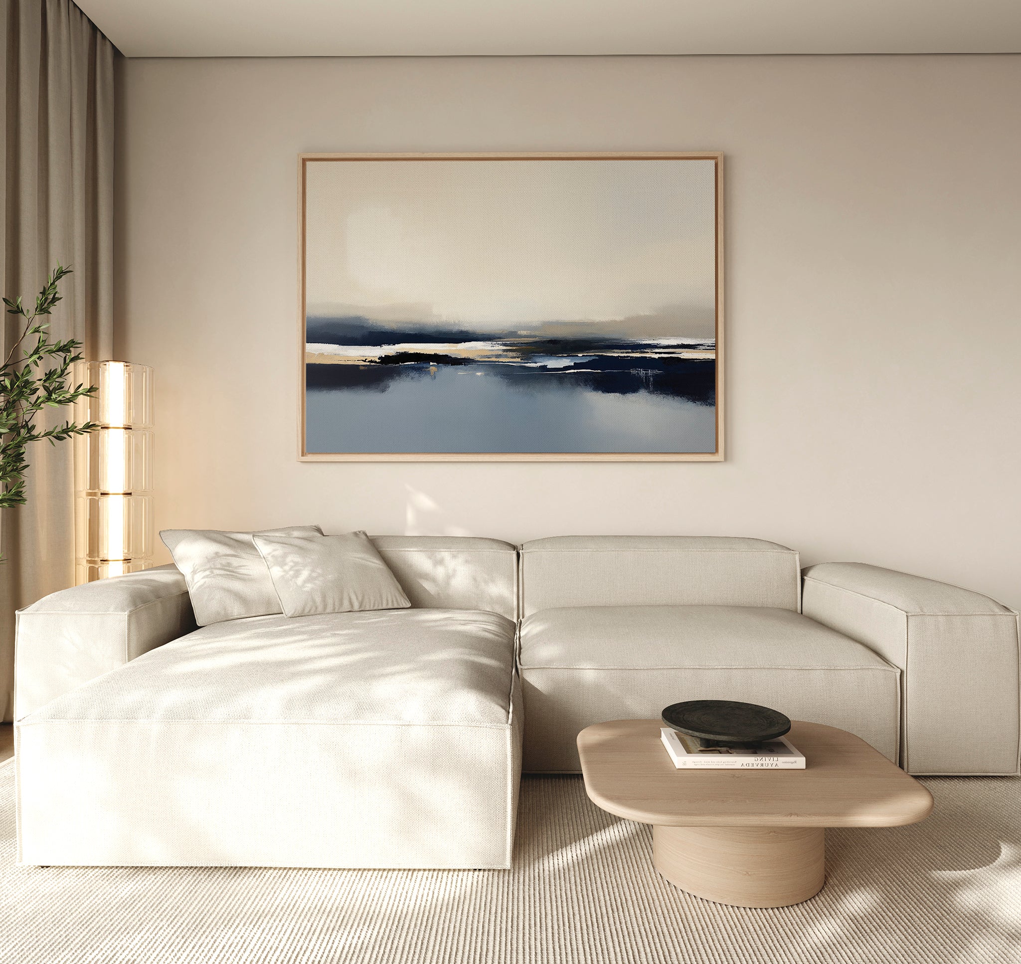 A modern living room features a light beige sectional, wooden coffee table, black decorative bowl, tall corner plant, and the Frozen Bay Canvas Art - Horizontal on the wall. Neutral tones and minimalist decor define this inviting space.
