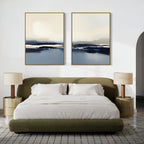 A modern bedroom featuring the Frozen Bay - Set Of 2 above a green upholstered bed with white bedding, two round nightstands with beige lamps, a gray rug, and striking abstract winter waters artwork as contemporary prints.