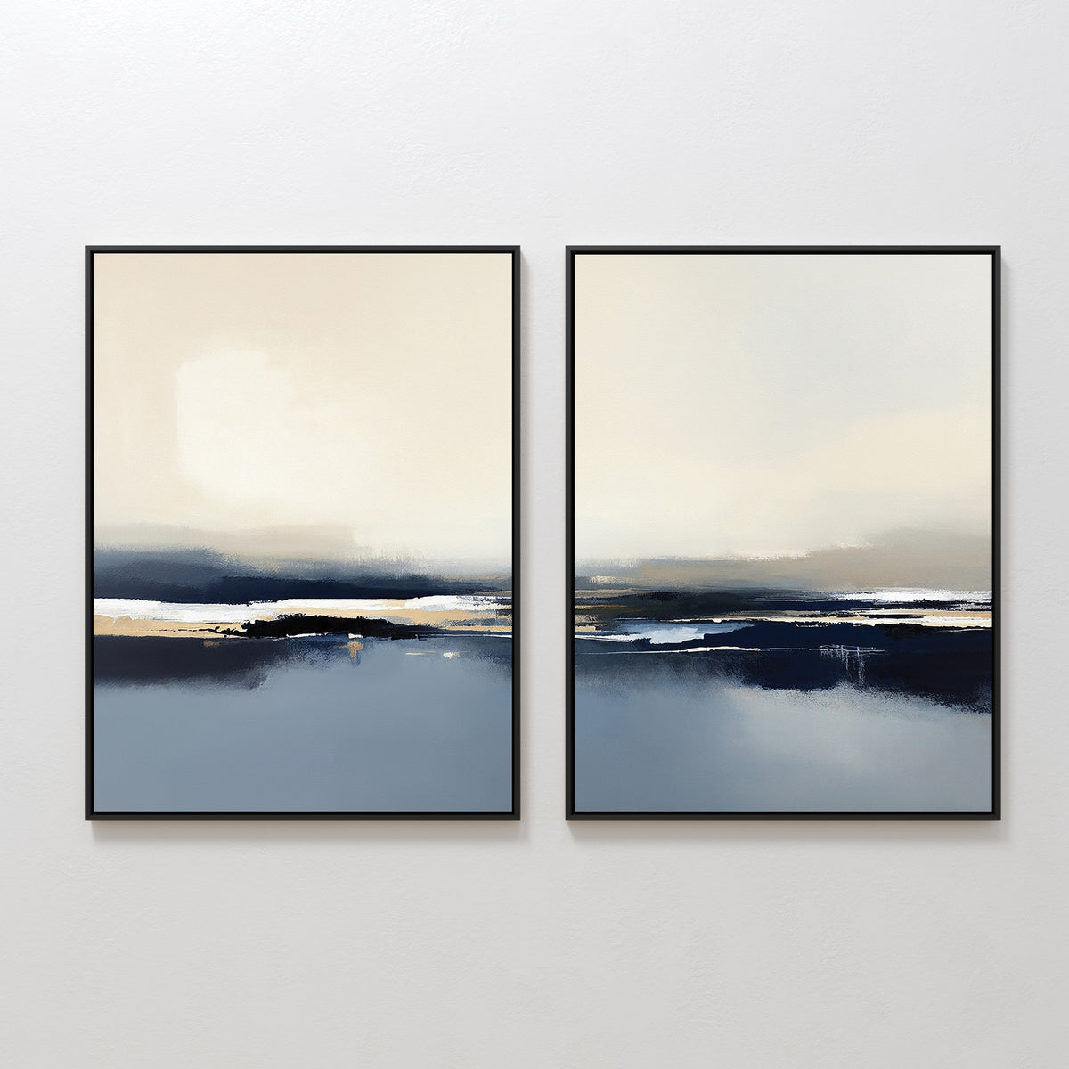 The Frozen Bay - Set Of 2 features framed abstract prints with soft beige, blue, and black tones, evoking tranquil seascapes. Displayed together on a white wall, they're ideal for modern living room decor with their serene, contemporary style.
