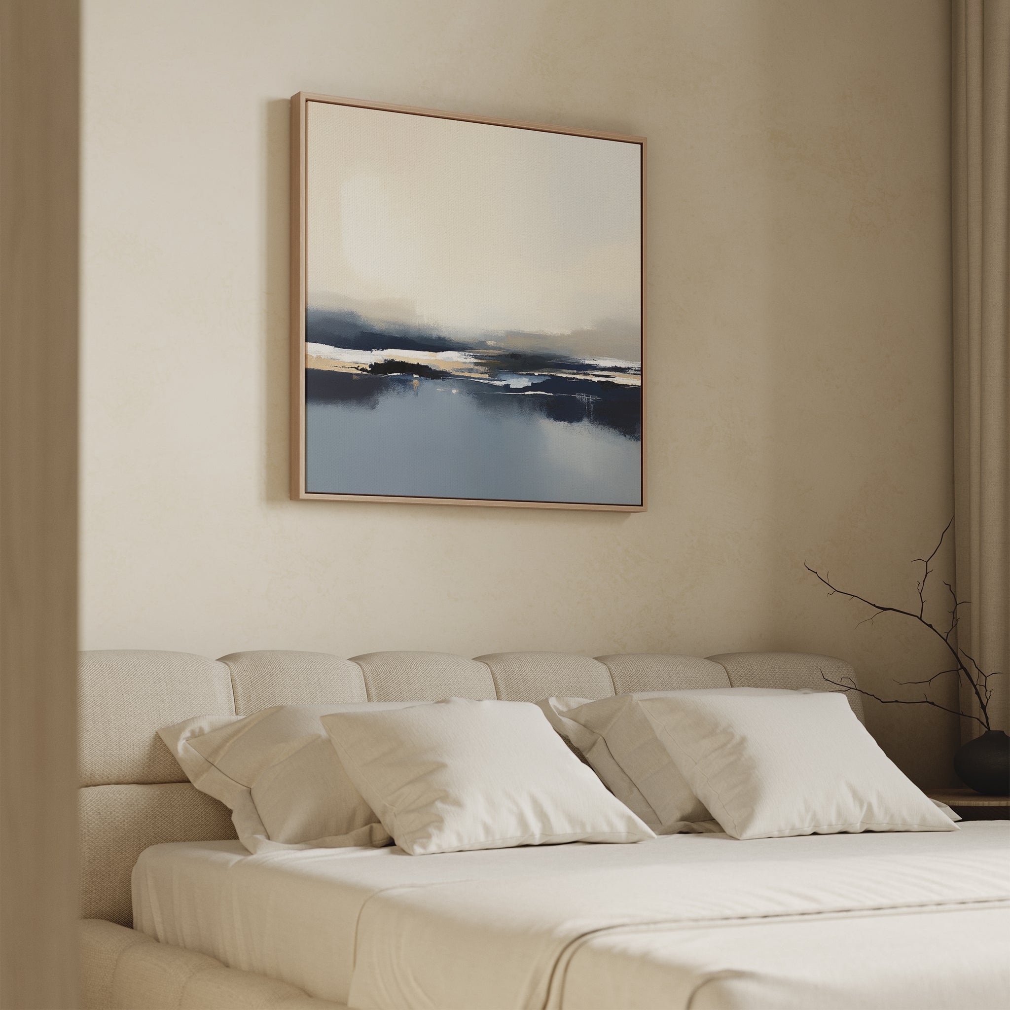 A minimalist bedroom features a beige tufted bed with four white pillows, a soft blanket, and the Frozen Bay Canvas Art - Square hanging above. A bare branch in a vase decorates the nightstand.