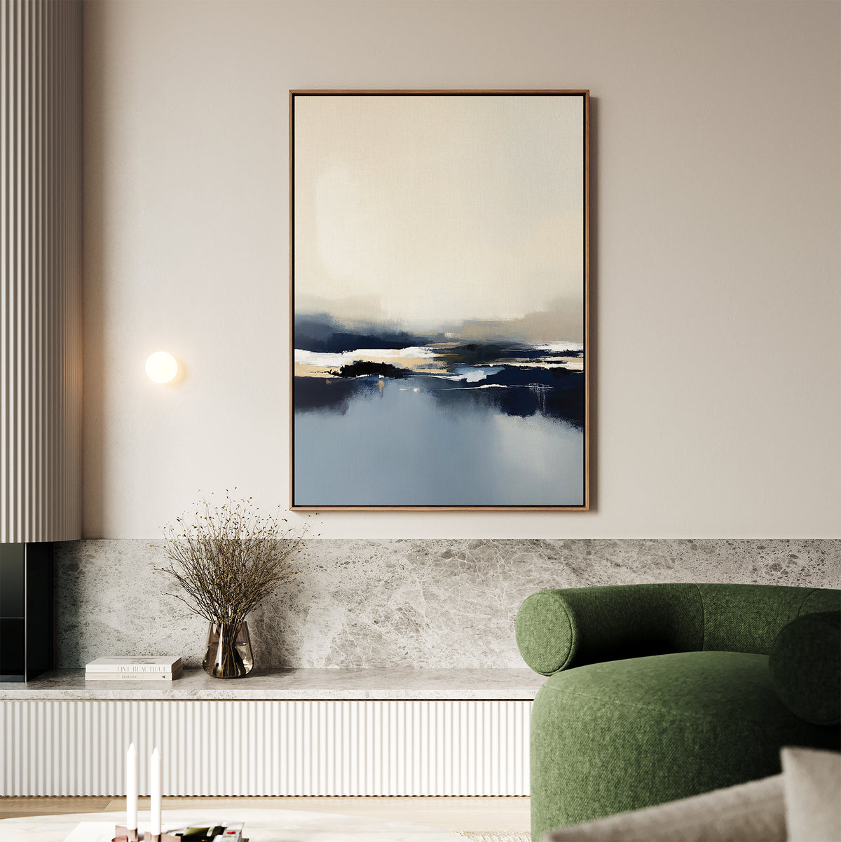 A modern living room featuring the Frozen Bay Canvas Art - Vertical above a marble shelf, with a round green sofa, vase of dried flowers, lit wall sconce, and minimalist neutral decor for a contemporary look.