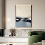 A modern living room featuring the Frozen Bay Canvas Art - Vertical above a marble shelf, with a round green sofa, vase of dried flowers, lit wall sconce, and minimalist neutral decor for a contemporary look.