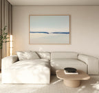 A modern living room featuring a light beige sectional, light wood coffee table with black bowl, tall corner plant, and the Frozen Channel Canvas Art - Horizontal above neutral walls—showcasing elegant modern décor.