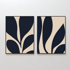 The Botanical Ink Set of 2 features abstract art prints with bold, dark organic shapes on a beige background, each framed in black—an eye-catching option for minimalist wall art in any modern home.