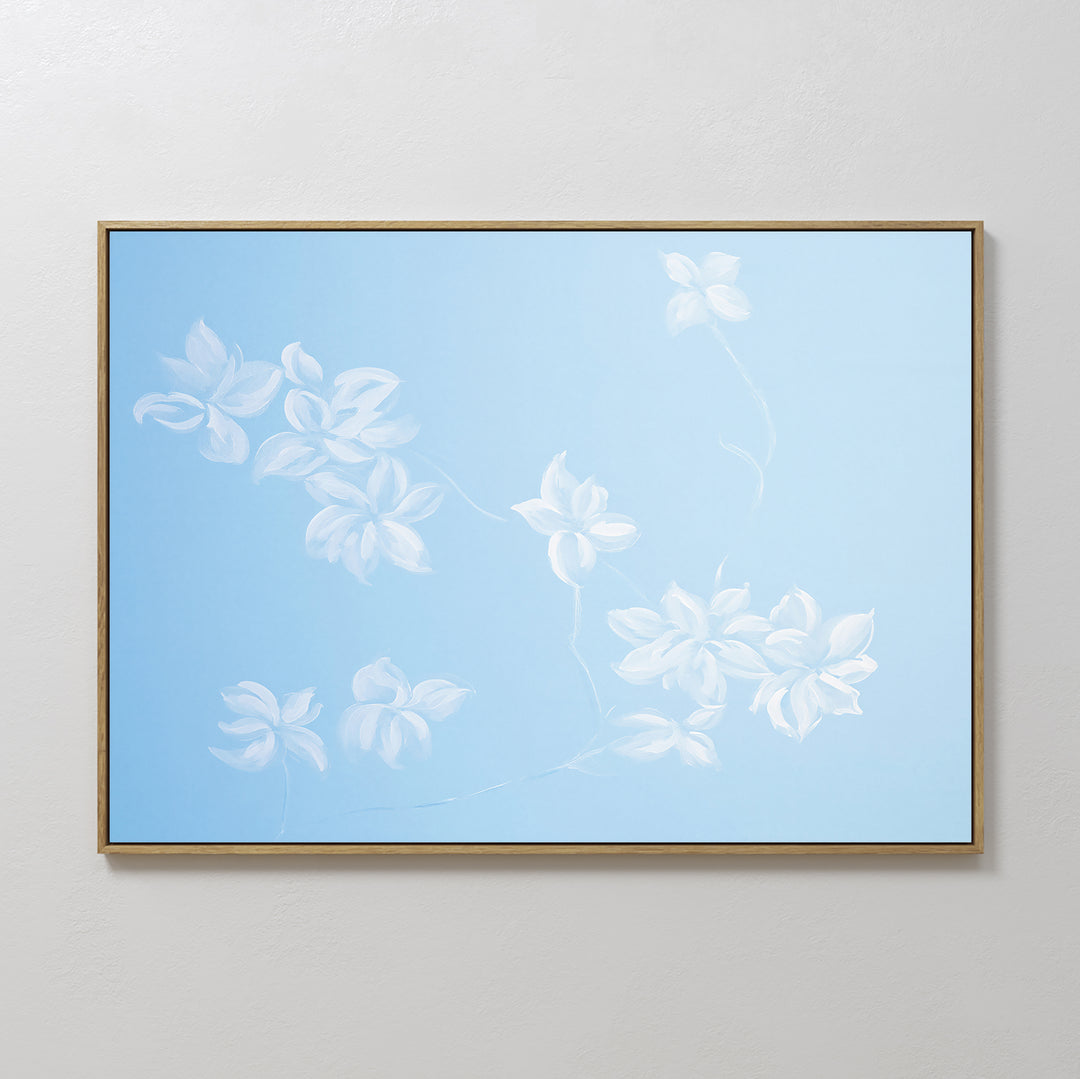 The Gentle Blossoms Canvas Art - Horizontal features delicate white flowers and branches on a soft sky blue background, adding an elegant floral touch to any neutral-colored wall.
