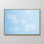 The Gentle Blossoms Canvas Art - Horizontal features delicate white flowers and branches on a soft sky blue background, adding an elegant floral touch to any neutral-colored wall.