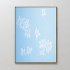 Gentle Blossoms Canvas Art - Vertical features delicate white abstract floral designs on a powder blue background, making it an elegant addition to any room's decor.