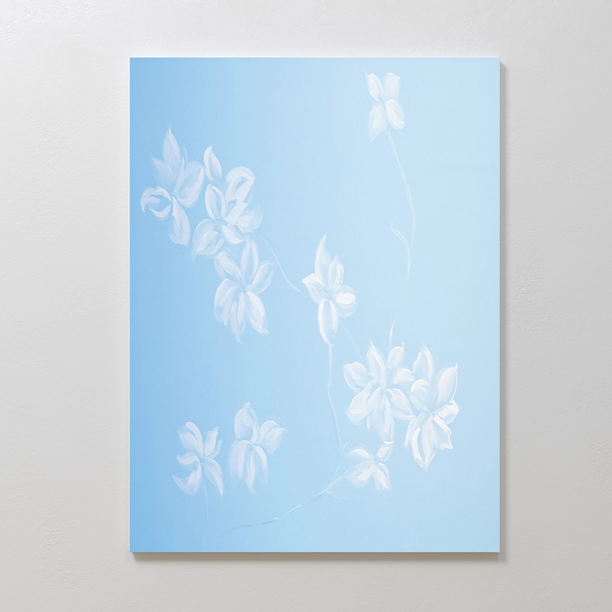 The Gentle Blossoms Canvas Art - Vertical displays delicate white flowers with thin stems on a soft powder blue background, creating light, airy, and minimalist floral wall decor.