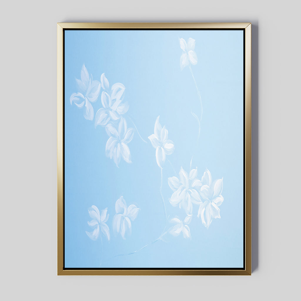 The Gentle Blossoms Canvas Art - Vertical features delicate white floral designs on a powder blue background, framed with a gold border for a soft, minimalist look.