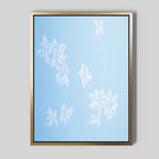 The Gentle Blossoms Canvas Art - Vertical features delicate white floral designs on a powder blue background, framed with a gold border for a soft, minimalist look.