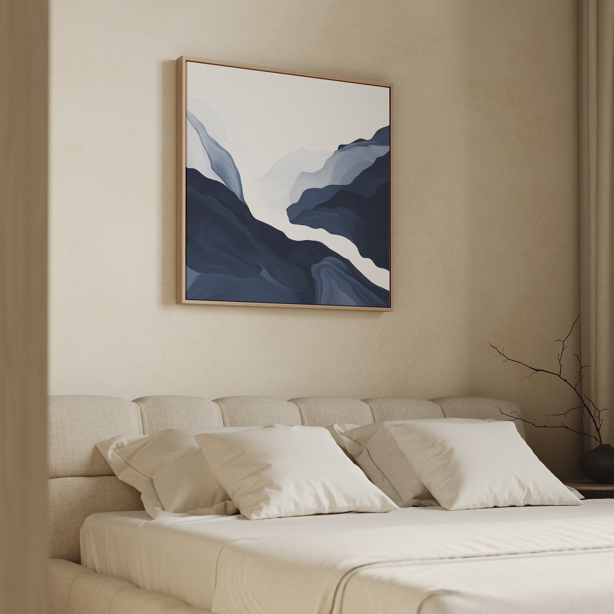 A modern bedroom features a beige upholstered bed with cream bedding and pillows. Above the bed hangs the Glacier Flow Canvas Art - Square, while light enters through a window with neutral curtains.