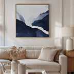 A modern living room with a beige sofa, neutral cushions, a wooden side table with a lamp, and Glacier Flow Canvas Art - Square. Dried flowers and decor on the coffee table enhance the stylish, contemporary feel.