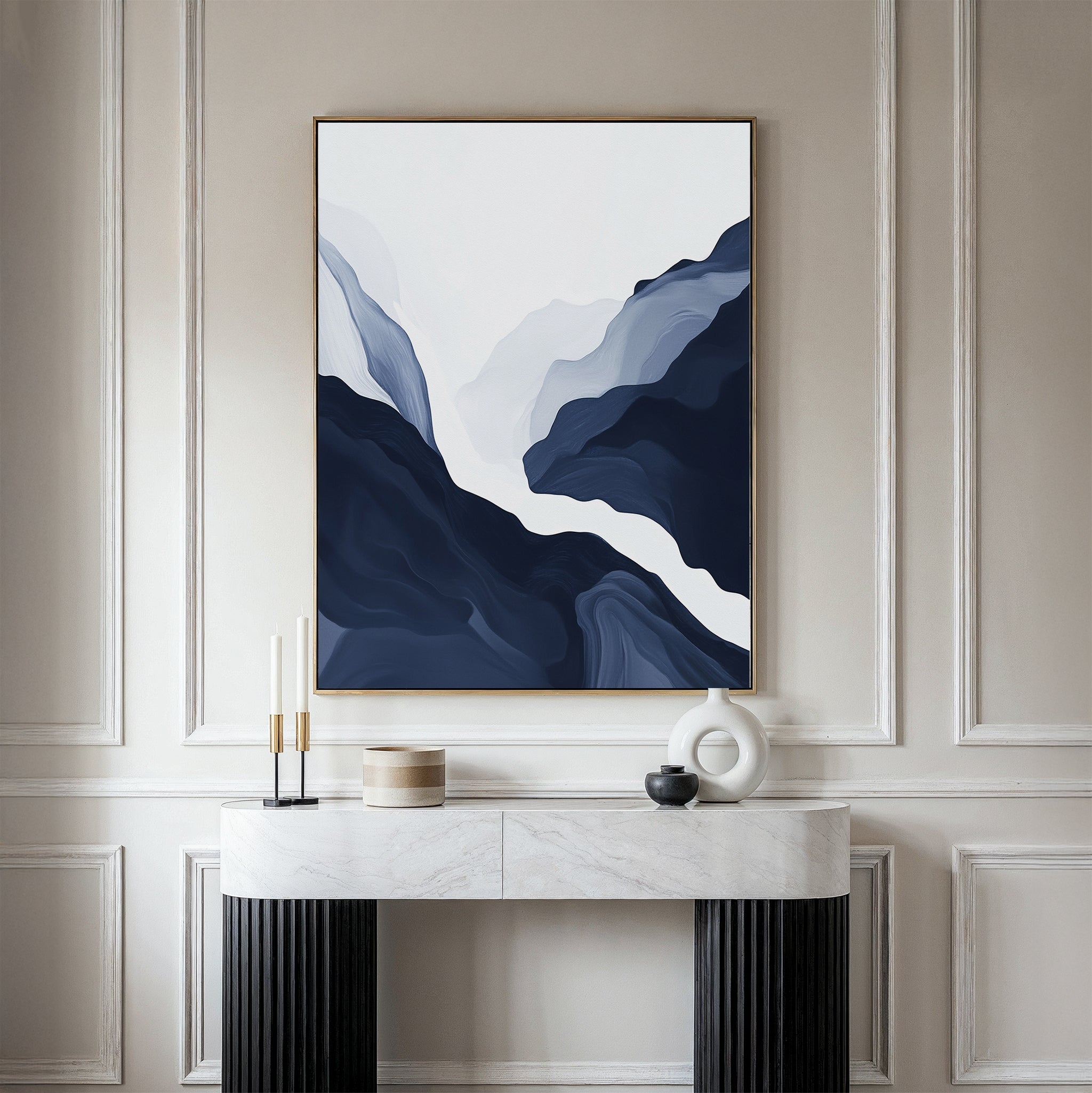 A minimalist interior showcases the Glacier Flow Canvas Art - Vertical in blue and white tones, mounted on a paneled beige wall above a marble console table with decor accents, adding a modern touch to the space.