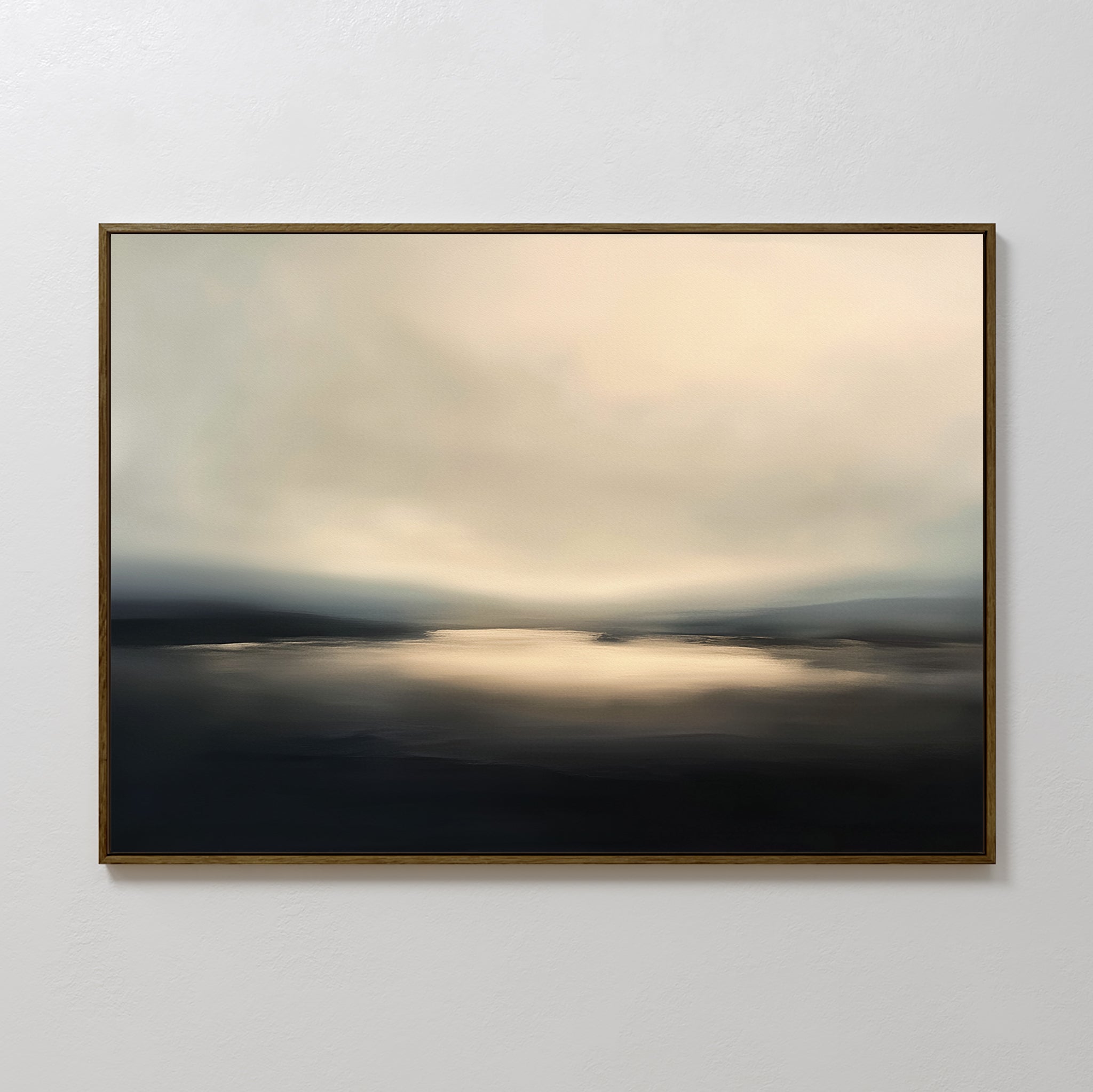 The Golden Fog Horizon Canvas Art - Horizontal is a framed abstract piece depicting a tranquil landscape with soft, blurred tones of beige, gray, and black and subtle light over water beneath a cloudy sky.
