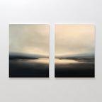 The "Golden Fog Horizon - Set of 2" features abstract coastal prints in soft beige, gray, and black tones, depicting serene water scenes under cloudy skies. Displayed side by side, they evoke the tranquil beauty of Nordic Park landscapes.