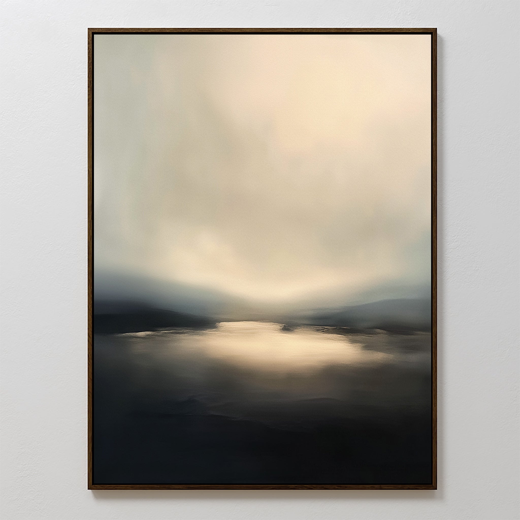 Golden Fog Horizon Canvas Art - Vertical features a moody, abstract landscape with soft beige, gray, and black tones. Gentle light reflects over water and distant hills beneath a calm sky in this serene framed print.
